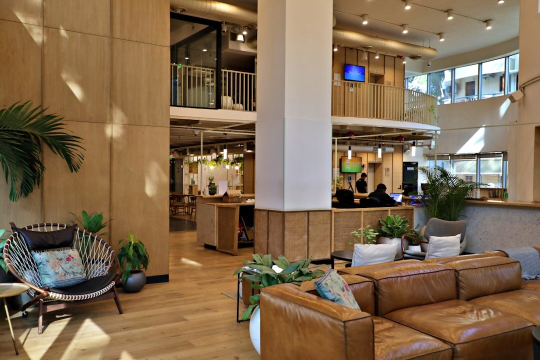 Modern coworking office space with wooden desks and plants