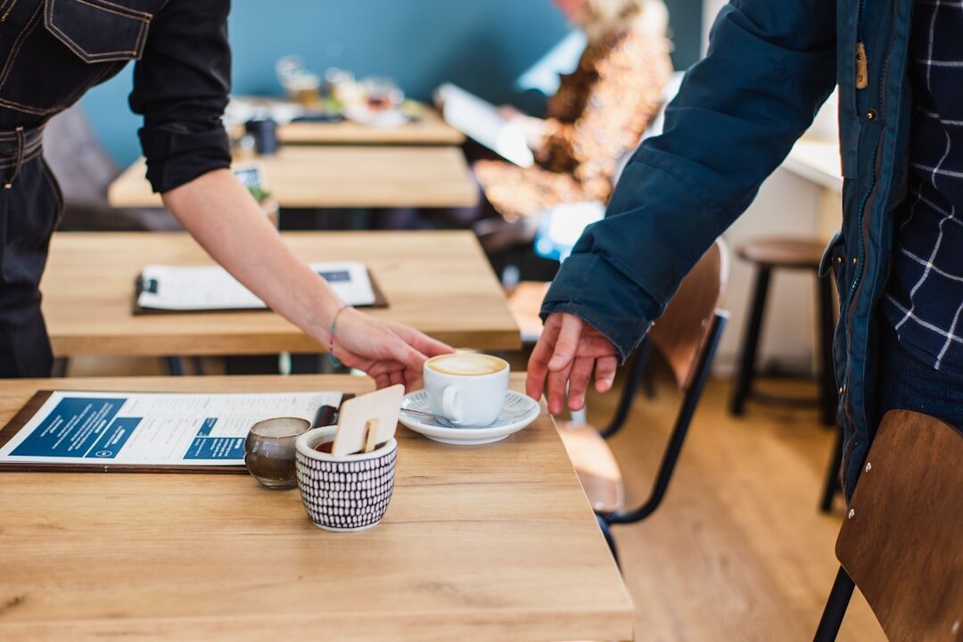 Two European business professionals having a coffee meeting and shaking hands