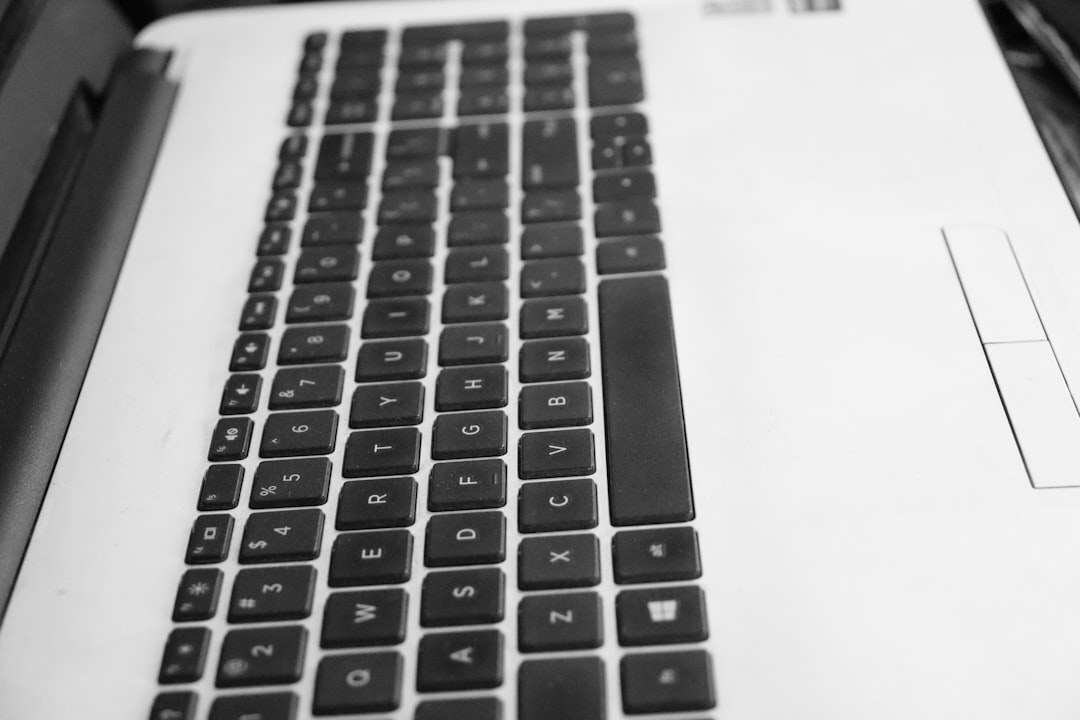 Close-up of hands typing on a laptop keyboard